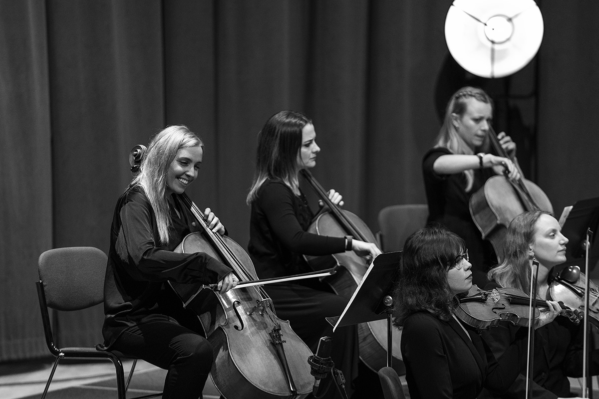 Katt Newlon, Lucy Andrews and Maddie Cutter (cellos) performing with the Down for the Count Orchestra at West Road Concert Hall, Cambridge