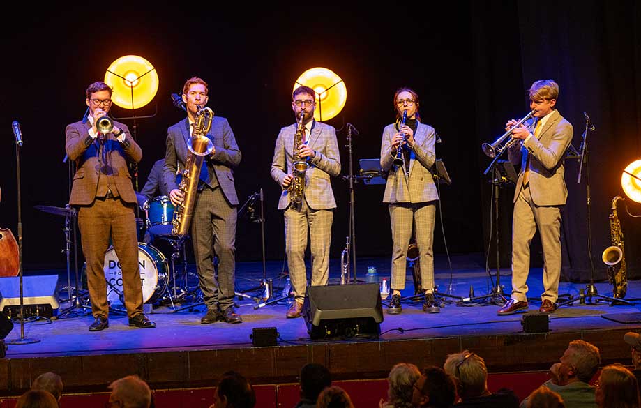 Saxophonist Alex Clarke performing with Down for the Count