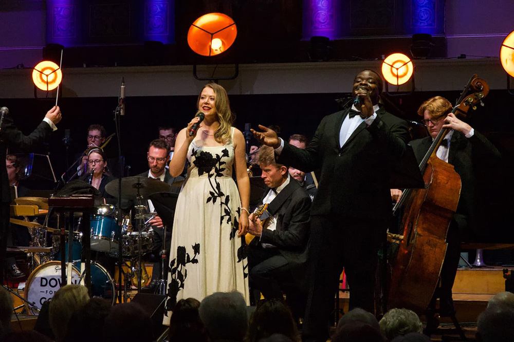 Vocalists Lydia Bell and Marvin Muoneké performing with Down for the Count Swing Orchestra